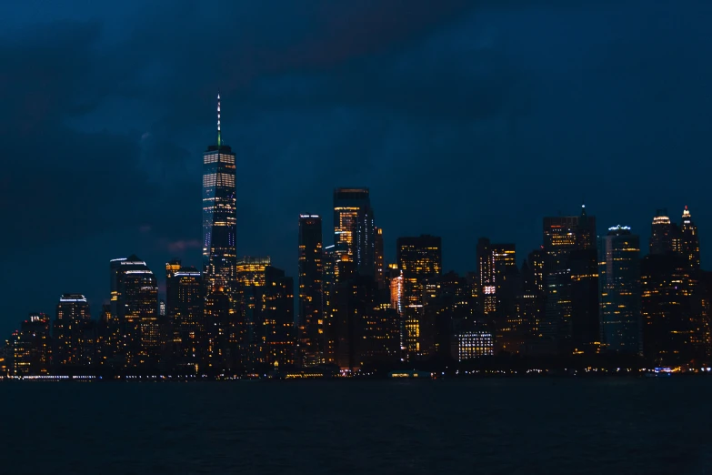 a skyline view of a city with buildings and lights at night