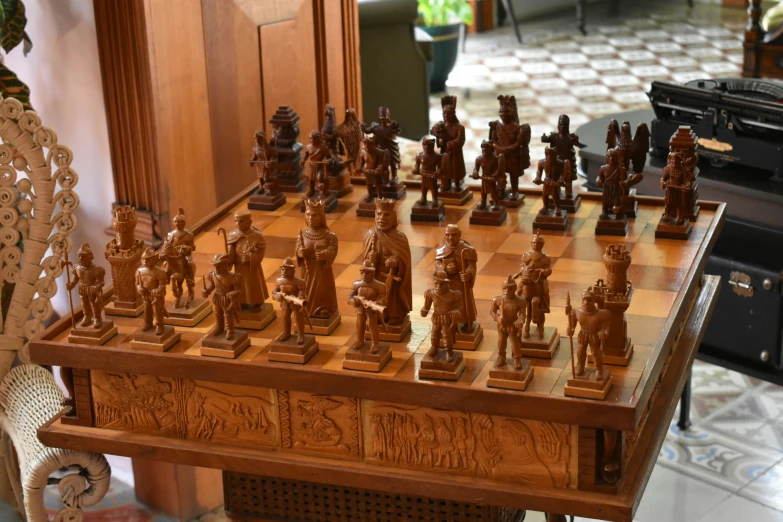 an elaborately carved chess set and stand in a room