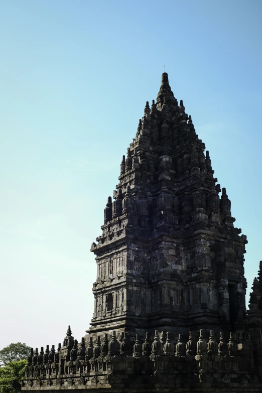 a black clock tower in the center of a stone structure