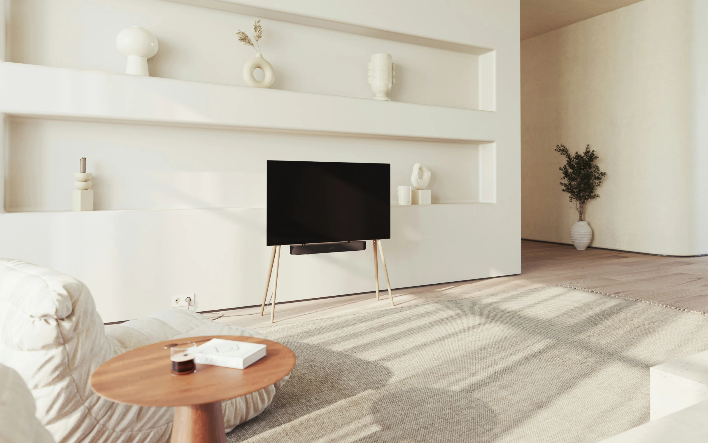 white walls with shelving above a black television