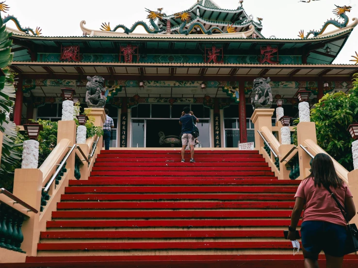 a person is standing on the top steps near red stairs