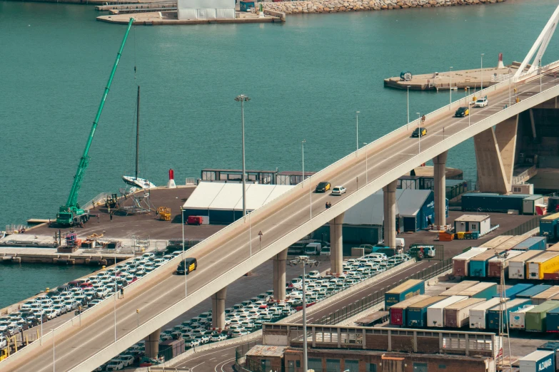 a highway bridge crosses over the water with several cars