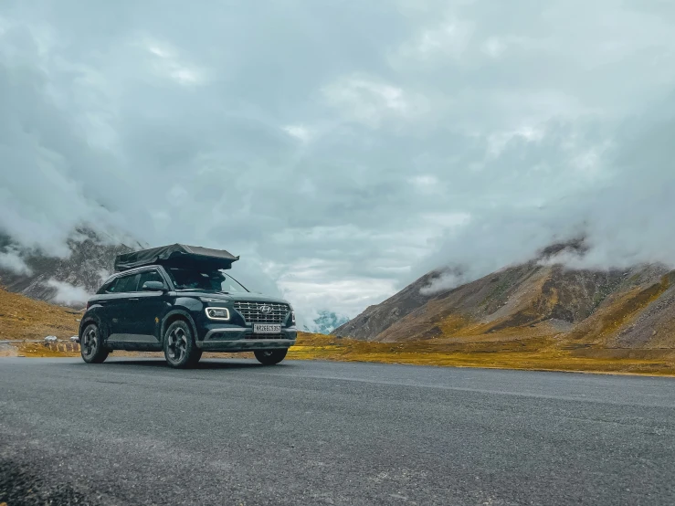 an suv has a camper attached to the back