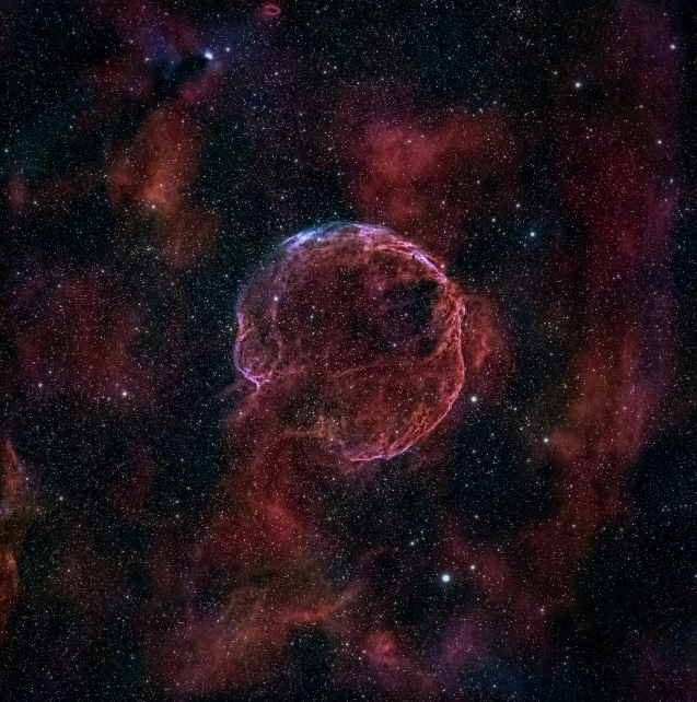 a pink ball of gas floating in the middle of space