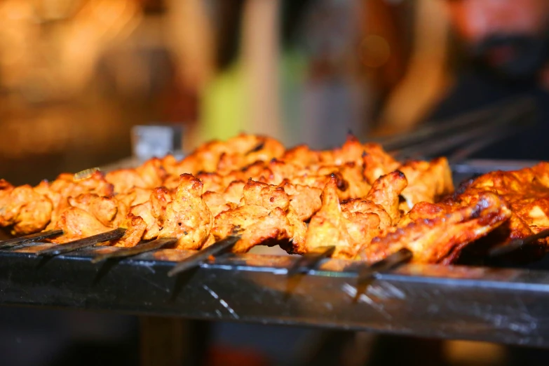 a bbq filled with chicken covered in cheese