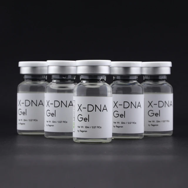 three bottles of x - dna and x - gf gel next to one another on a gray surface