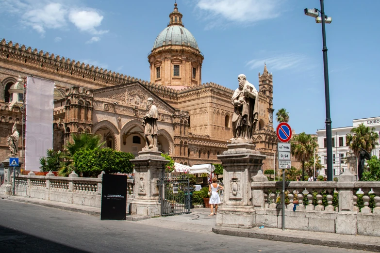 the large building has a tall clock tower in front