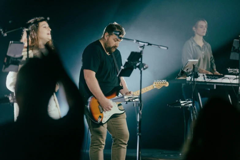 two people are playing musical instruments on stage