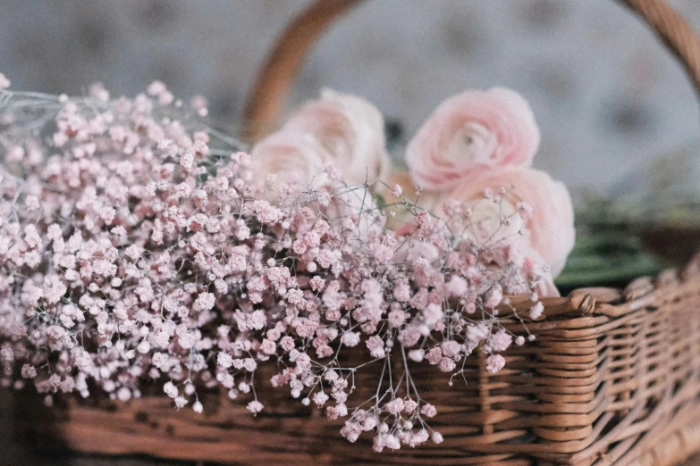 flowers on top of the baby's breath in a basket