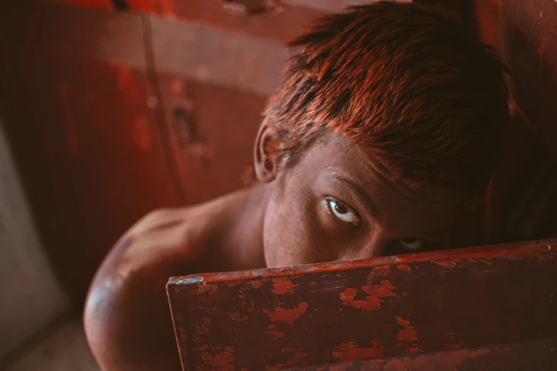 an image of a person peeking over a box