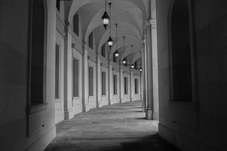 a dark hallway leads to two rows of tall pillars