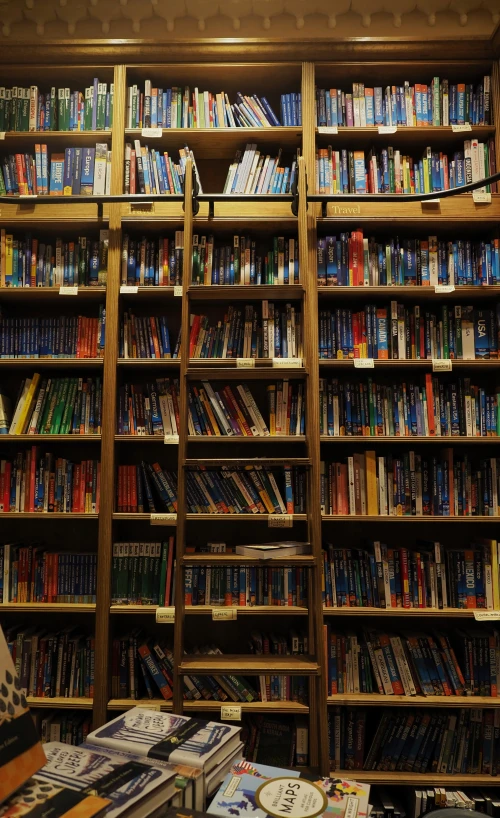 bookshelves filled with books and various types of magazines