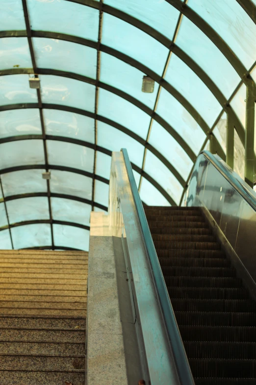 a person riding an escalator in an airport