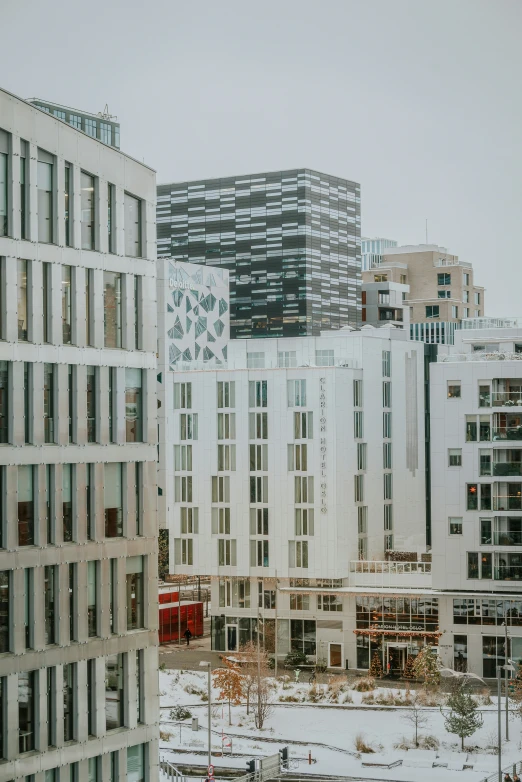 a city area covered in snow near a group of tall buildings