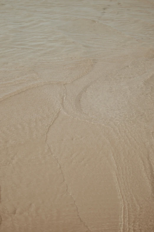 someone surfing in the surf on a beach