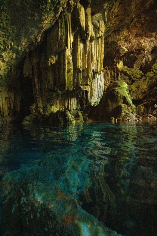 the interior of a cave with water surrounding