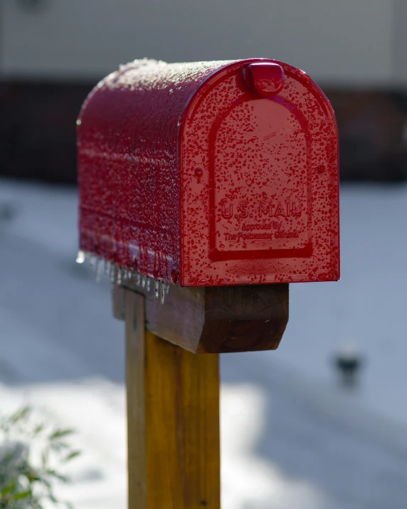 the red mailbox is in a snow covered residential area
