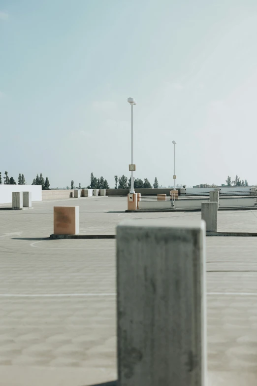 a parking lot with several structures in the background