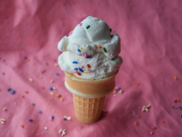 a vanilla cone has sprinkles and ice cream in it