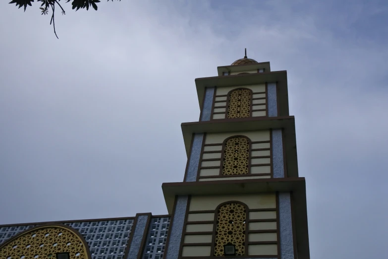 the large tower of this building is made out of multicolored wood