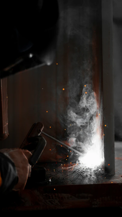 welder working in an industrial area with steel