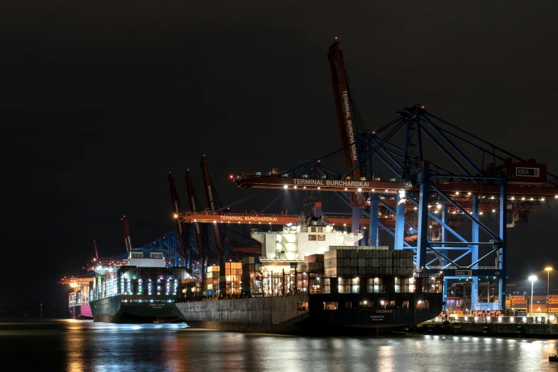 a huge ship sitting on top of a body of water at night