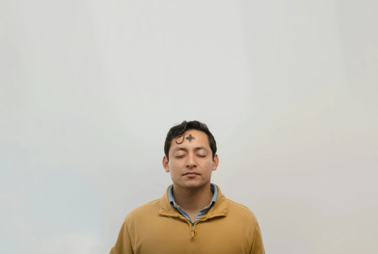 a man taking a picture with his eyes closed