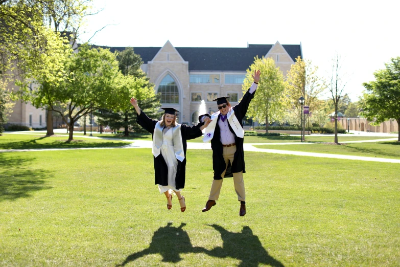 two people in costume jumping in a field