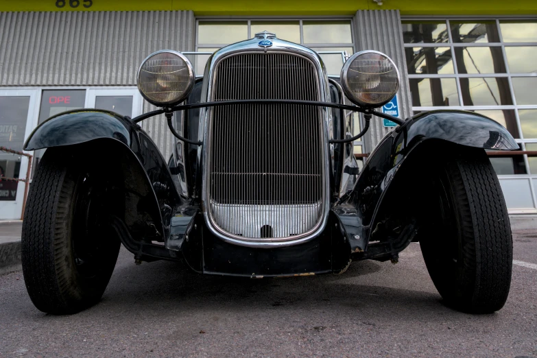 an old fashioned buggy is sitting in front of a building