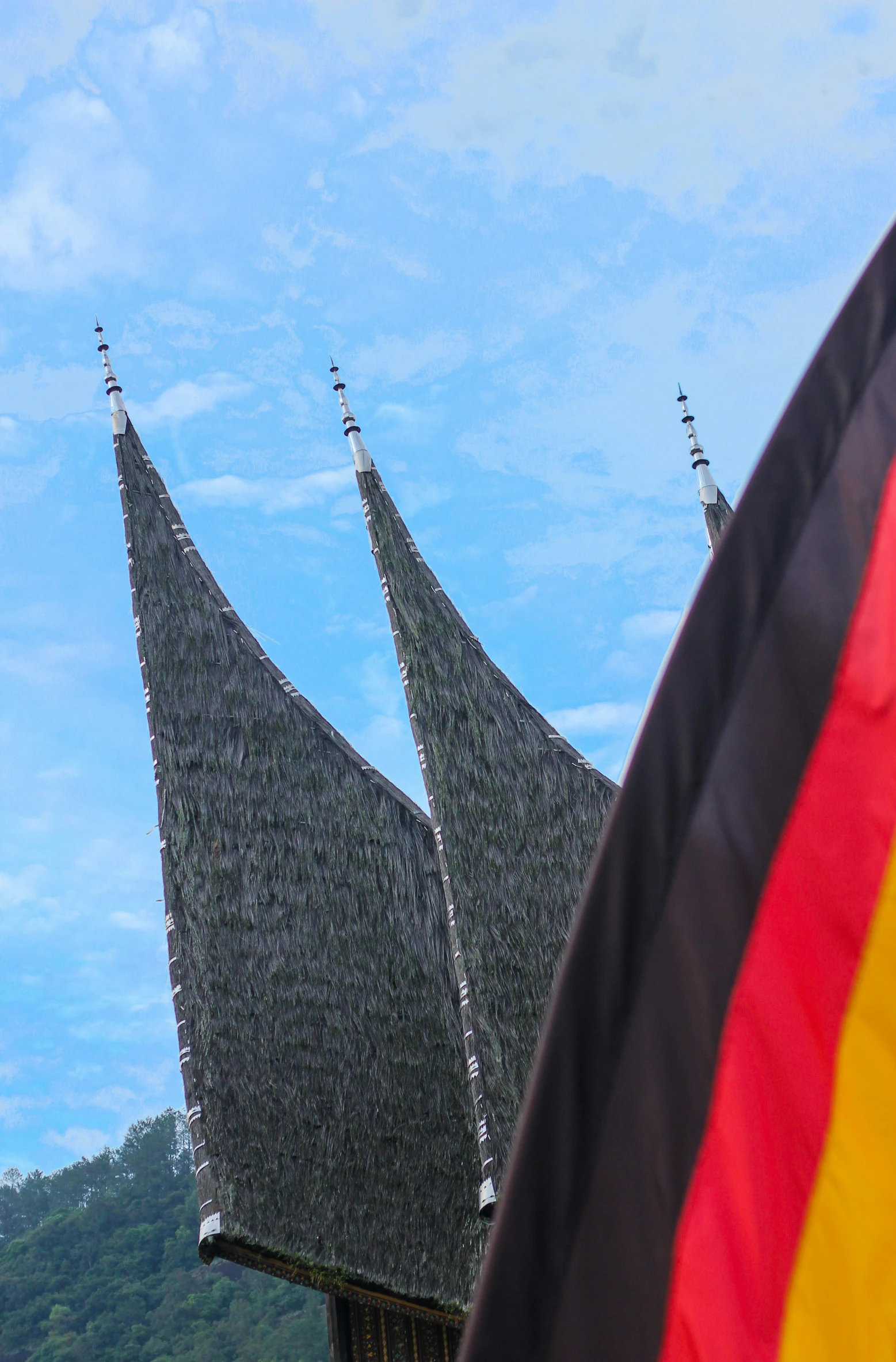 the roof of two buildings with large sails are against the blue sky