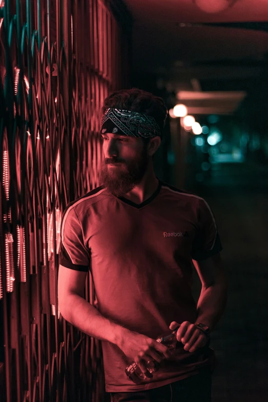 man in red standing next to an old - fashioned fence