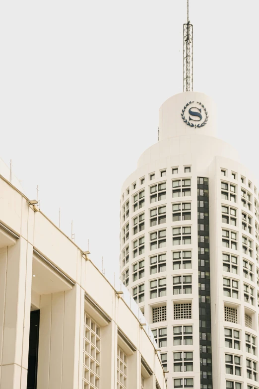 the tower of a building next to another building with a clock