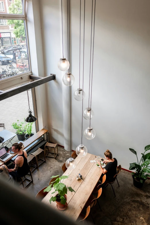 people at tables in a cafe having dinner