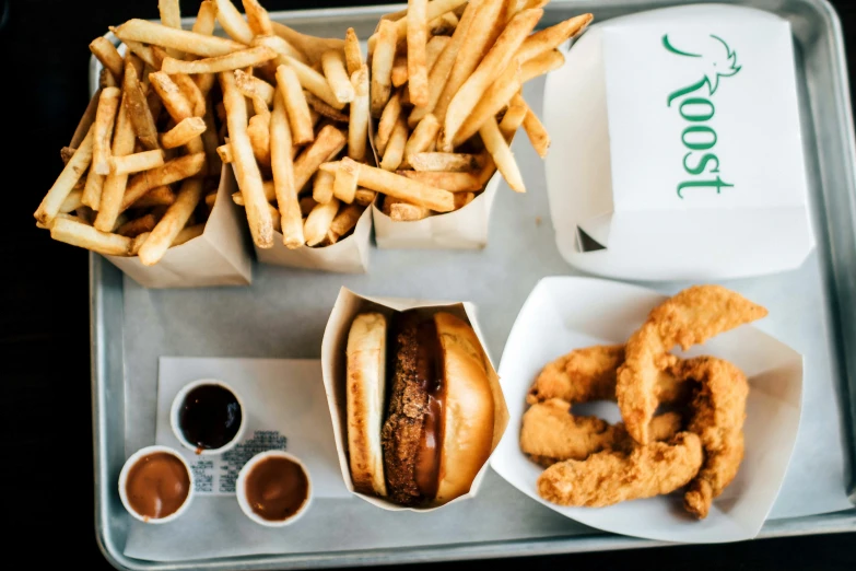 the tray has three hamburgers, two soda fries and four other snacks