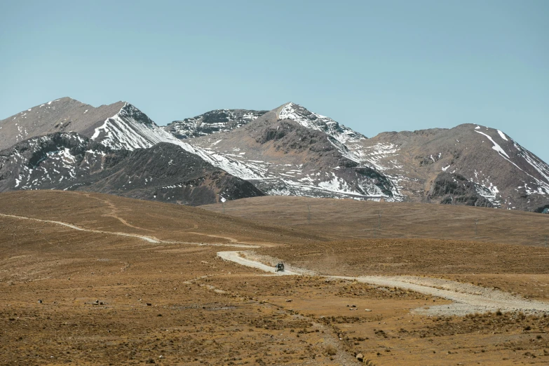 a person on a horse in front of some mountain range