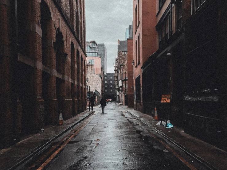 a city street is very wet and dark