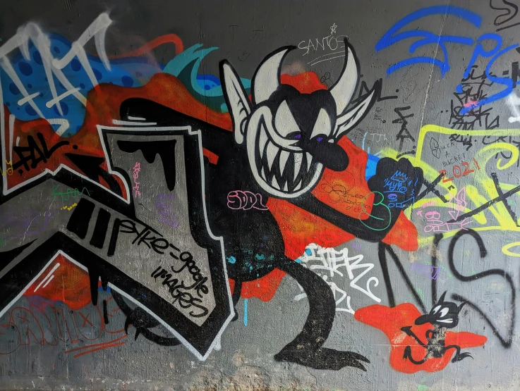 a wall with some graffiti on it in different colors