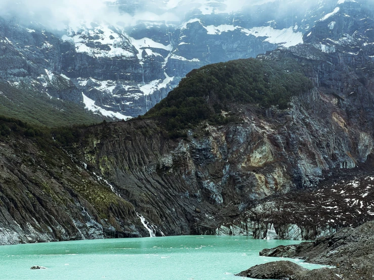 a snowy mountain in the middle of a river