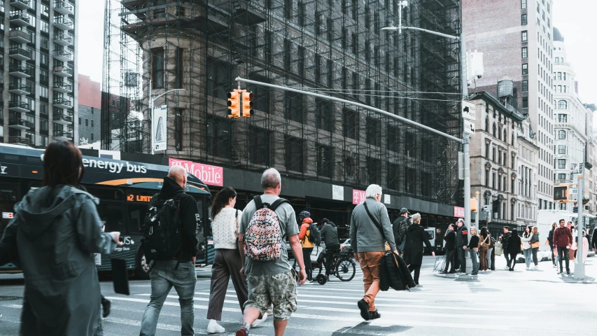 some people a street traffic lights buildings and people