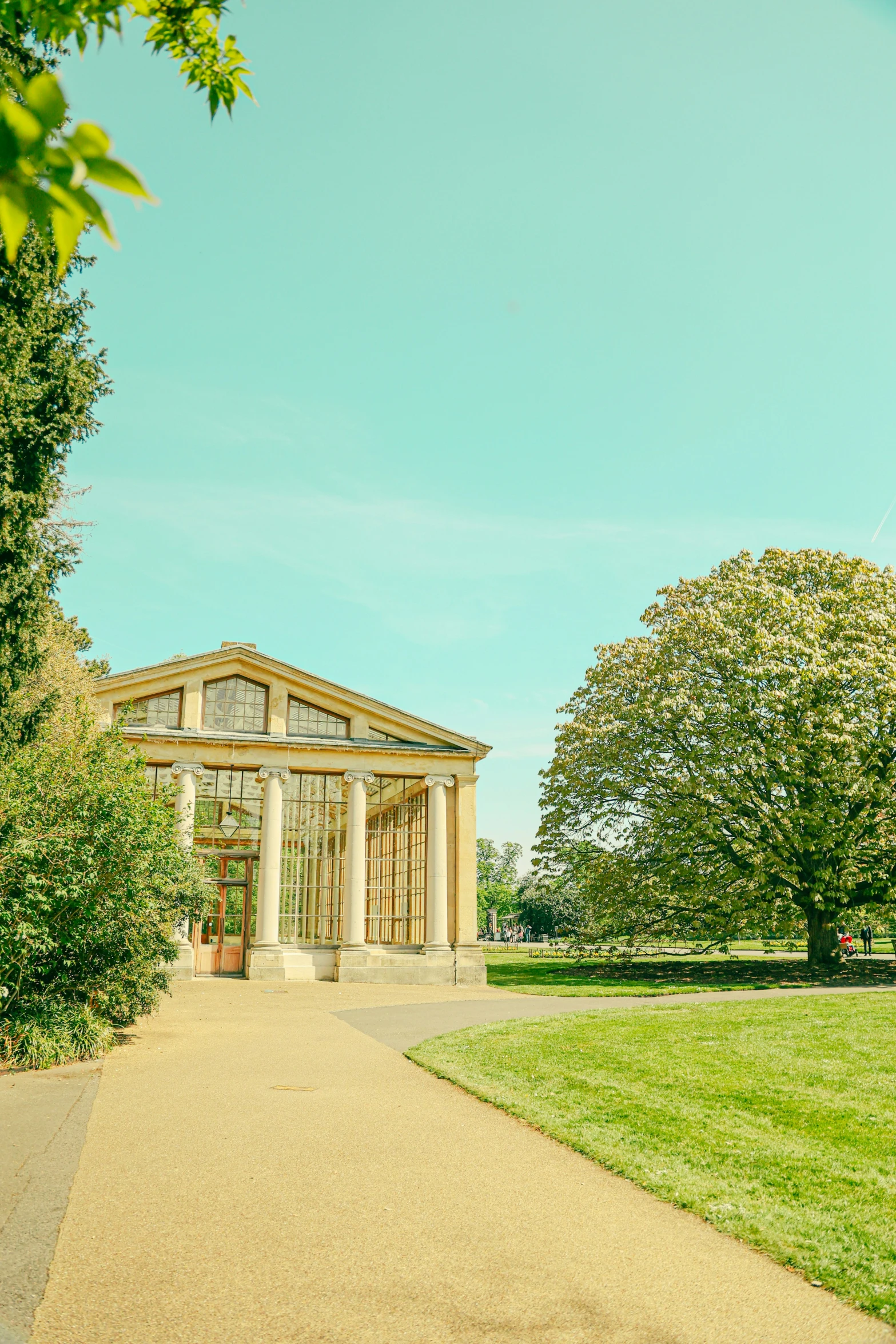 an outdoor stone house surrounded by greenery on the lawn