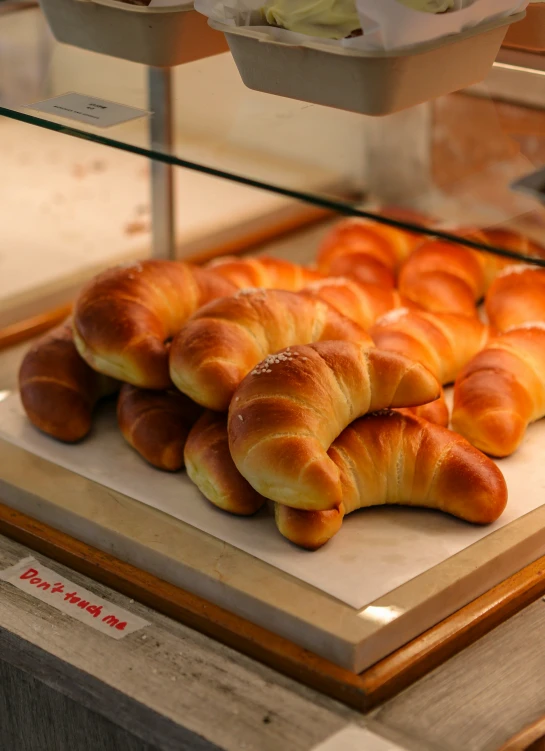 bread croissants are laying in a circle on display