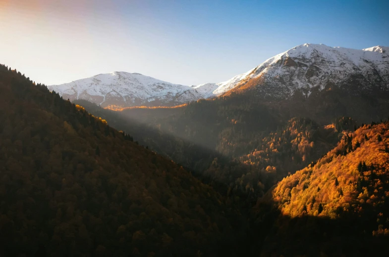 a mountain with snow capped mountains in the distance