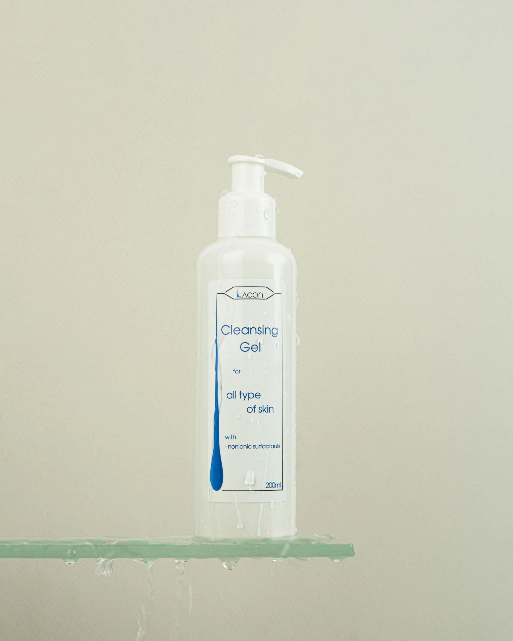 a bottle of shampoo sits atop a green shelf