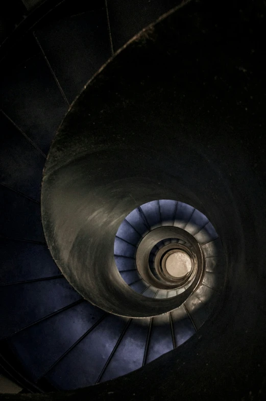 there is a spiral staircase made up from a black background