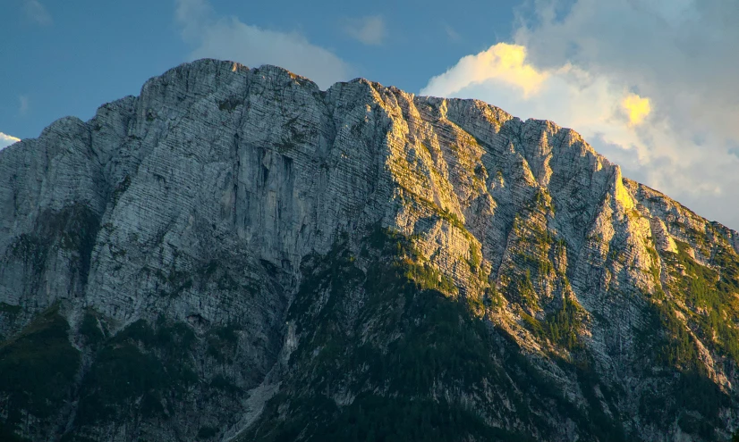 a tall mountain with a lot of clouds above