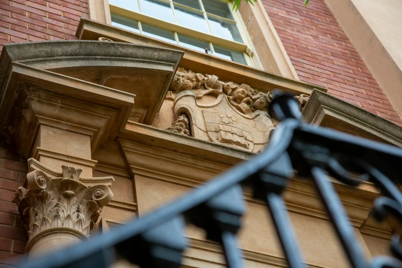 an ornate stone arch is against a red brick building