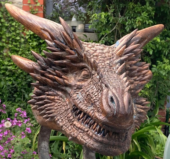 a close up of a metal head with long horns