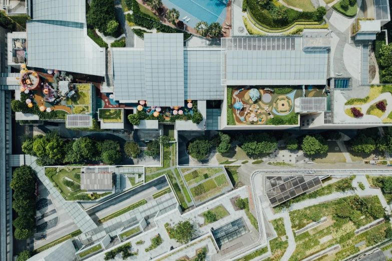 aerial view of buildings, trees, cars and roads