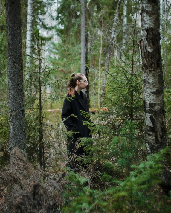 woman in the middle of the woods with a forest backdrop