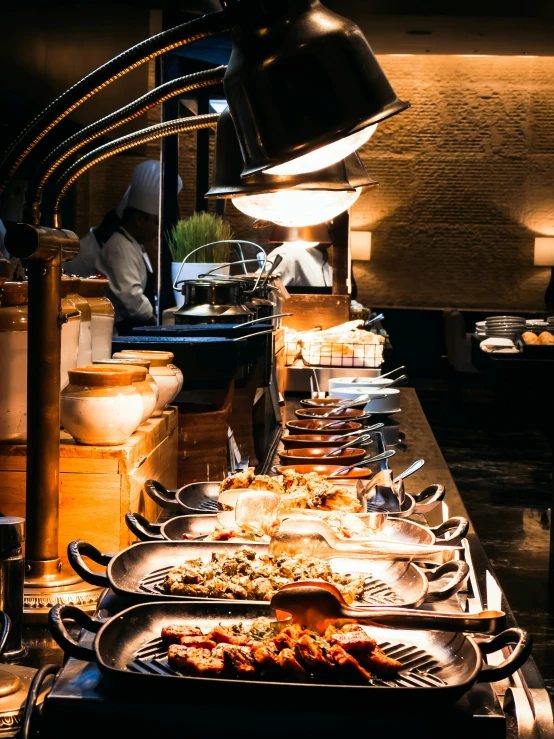 many plates are lined up to be cooked on a buffet